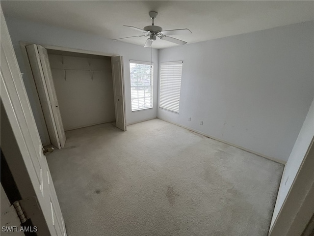 13020 Hamilton Harbour Dr Unit I3, Naples, FL 34110 - unfurnished bedroom with light carpet, a closet, and a ceiling fan
