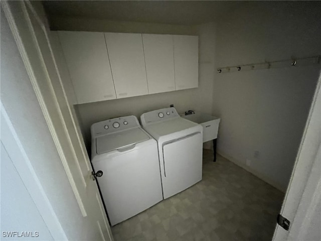 13020 Hamilton Harbour Dr Unit I3, Naples, FL 34110 - washroom with washing machine and clothes dryer, cabinet space, and light flooring