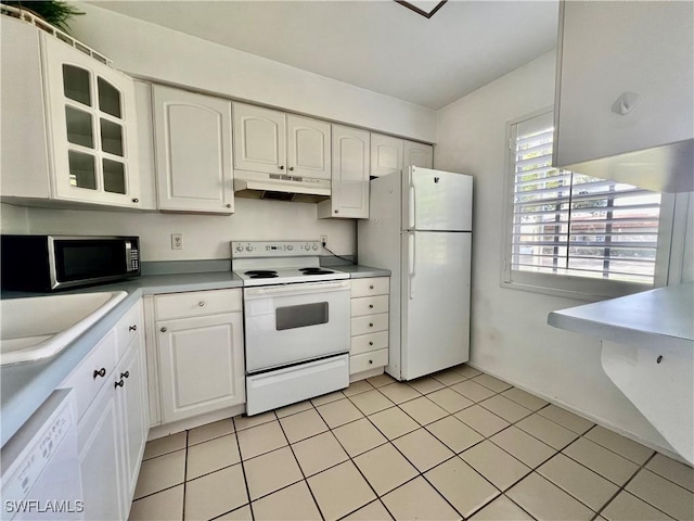 6300 S Pointe Blvd Unit 312, Fort Myers, FL 33919 - kitchen with white appliances, under cabinet range hood, white cabinets, glass insert cabinets, and light tile patterned floors