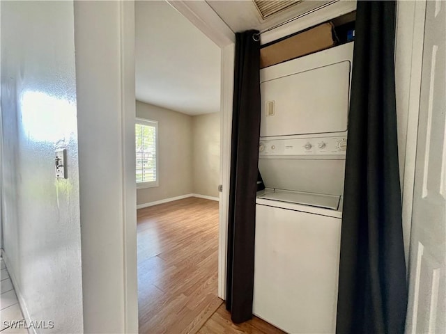 6300 S Pointe Blvd Unit 312, Fort Myers, FL 33919 - laundry room with stacked washer / dryer and light wood-style floors