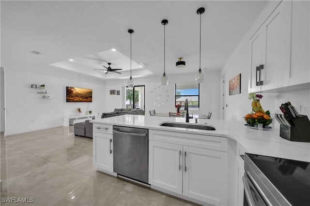 2607 4th St SW, Lehigh Acres, FL 33976 - kitchen with stainless steel appliances, a peninsula, white cabinets, open floor plan, and ceiling fan