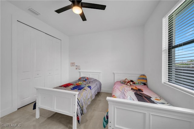 2607 4th St SW, Lehigh Acres, FL 33976 - bedroom with light tile patterned floors, a ceiling fan, and a closet