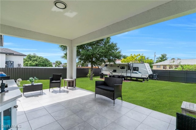 2607 4th St SW, Lehigh Acres, FL 33976 - fenced backyard with a patio area and an outdoor hangout area