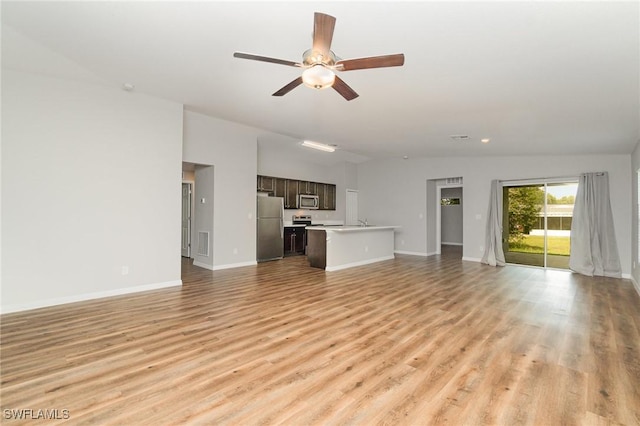 1492 Schenley St, Port Charlotte, FL 33952 - unfurnished living room featuring ceiling fan, light wood finished floors, and recessed lighting