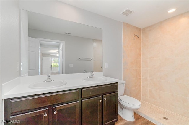 1492 Schenley St, Port Charlotte, FL 33952 - bathroom with double vanity, tiled shower, and wood finished floors