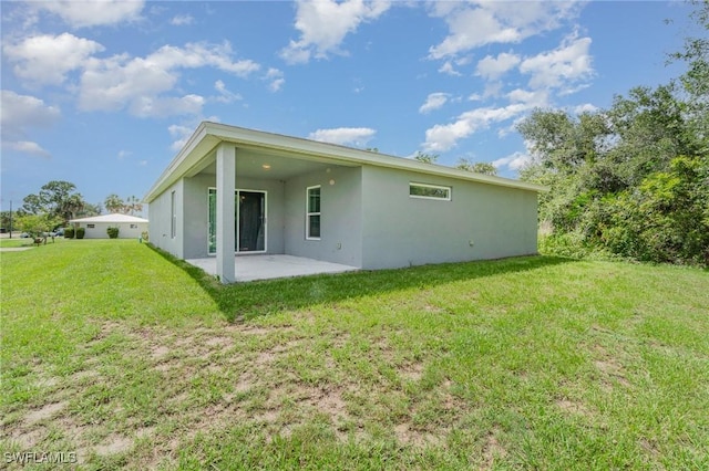 1492 Schenley St, Port Charlotte, FL 33952 - back of property with a patio, stucco siding, and a yard