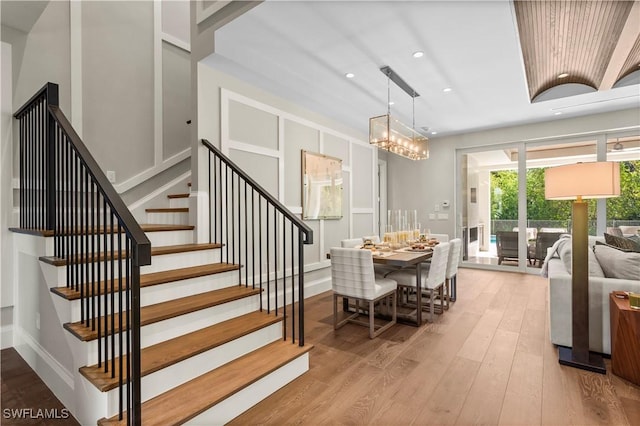 61 14th St S, Naples, FL 34102 - dining area featuring stairs, wood finished floors, a chandelier, and recessed lighting