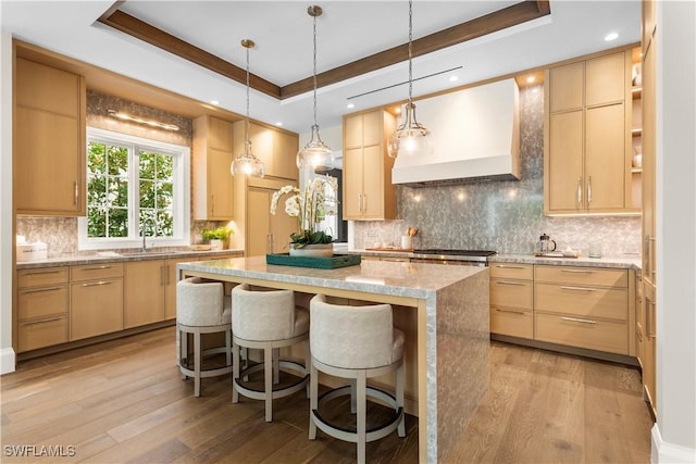 61 14th St S, Naples, FL 34102 - kitchen featuring custom range hood, a raised ceiling, light brown cabinetry, and recessed lighting