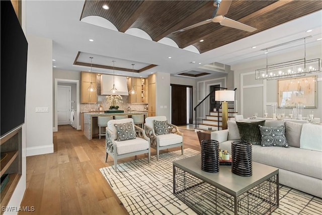 61 14th St S, Naples, FL 34102 - living area with stairway, wooden ceiling, light wood-style flooring, a chandelier, and ceiling fan