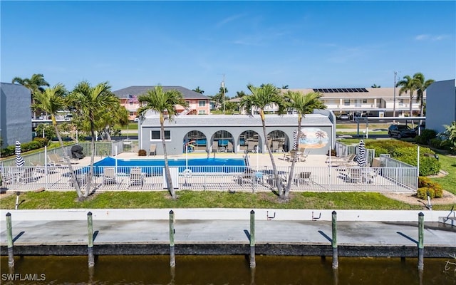 4549 SE 5th Pl Unit 211, Cape Coral, FL 33904 - rear view of property with a community pool, a patio area, and a water view