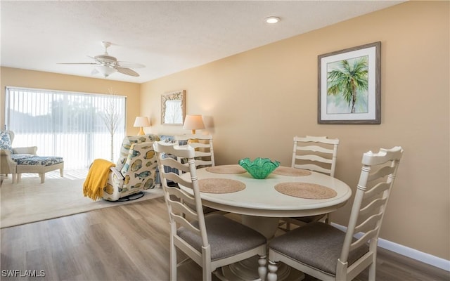 4549 SE 5th Pl Unit 211, Cape Coral, FL 33904 - dining area with a ceiling fan and wood finished floors