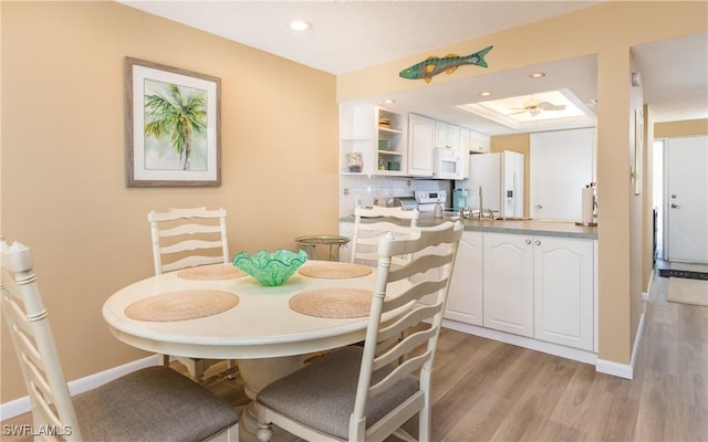 4549 SE 5th Pl Unit 211, Cape Coral, FL 33904 - dining room with a raised ceiling, light wood finished floors, recessed lighting, and a ceiling fan