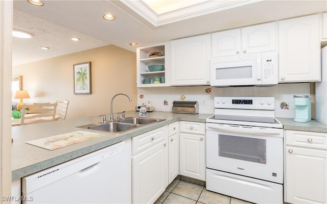 4549 SE 5th Pl Unit 211, Cape Coral, FL 33904 - kitchen with white appliances, recessed lighting, a peninsula, and white cabinetry