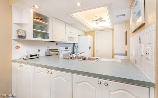 4549 SE 5th Pl Unit 211, Cape Coral, FL 33904 - kitchen featuring white appliances, white cabinetry, tasteful backsplash, ceiling fan, and a raised ceiling