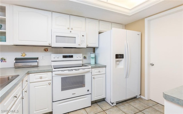 4549 SE 5th Pl Unit 211, Cape Coral, FL 33904 - kitchen featuring white appliances, white cabinets, light tile patterned floors, and tasteful backsplash