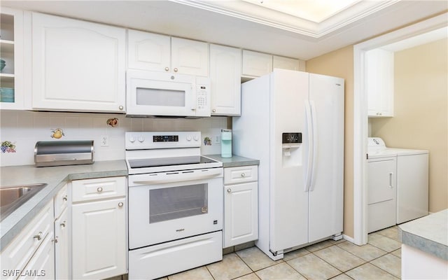 4549 SE 5th Pl Unit 211, Cape Coral, FL 33904 - kitchen with white appliances, separate washer and dryer, and white cabinets