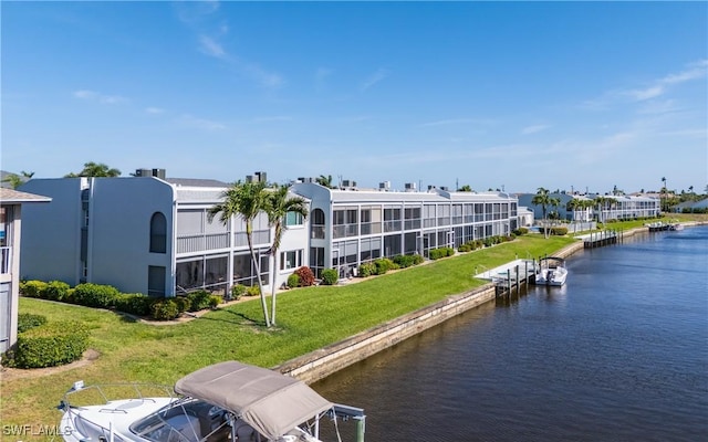 4549 SE 5th Pl Unit 211, Cape Coral, FL 33904 - dock area featuring a water view and a lawn
