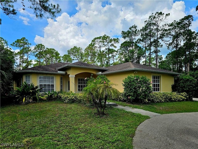 2640 4th Ave NE, Naples, FL 34120 - ranch-style house featuring stucco siding and a front yard