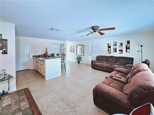 2640 4th Ave NE, Naples, FL 34120 - living room with ceiling fan and light tile patterned floors