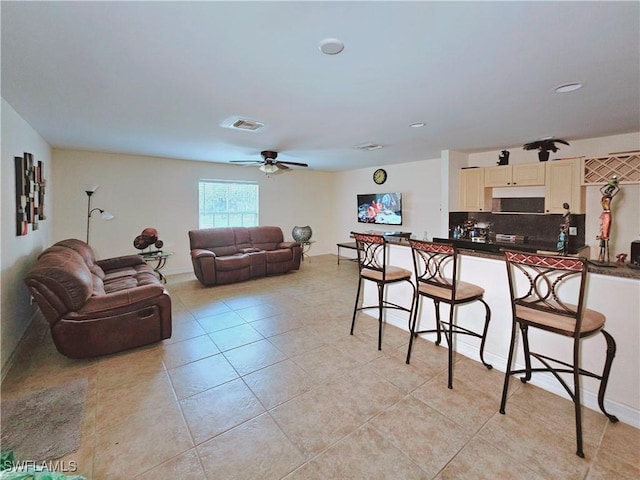 2640 4th Ave NE, Naples, FL 34120 - kitchen featuring dark countertops, a kitchen bar, open floor plan, and ceiling fan