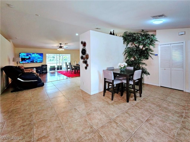 2640 4th Ave NE, Naples, FL 34120 - tiled dining area with a ceiling fan and baseboards