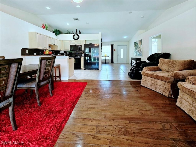 2640 4th Ave NE, Naples, FL 34120 - living room with vaulted ceiling and light wood finished floors