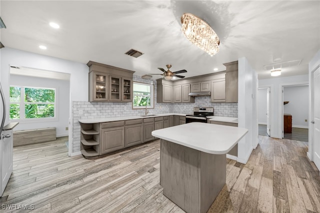 19350 Meredith Rd, North Fort Myers, FL 33917 - kitchen featuring electric range, under cabinet range hood, plenty of natural light, light countertops, and recessed lighting