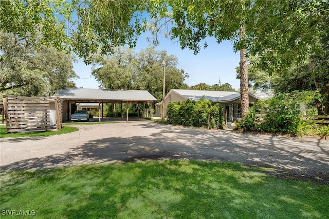 19350 Meredith Rd, North Fort Myers, FL 33917 - view of front of property with dirt driveway, a front lawn, and a carport