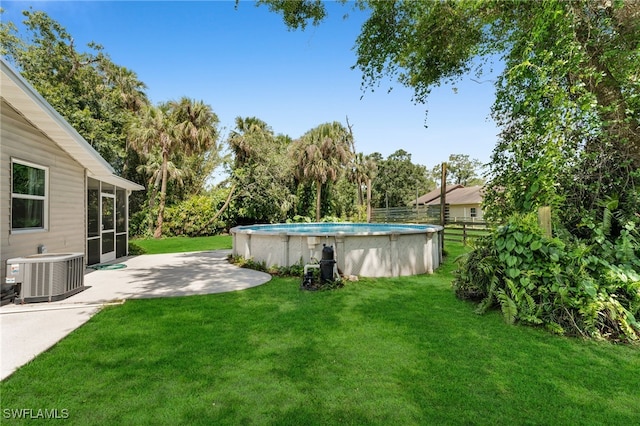 19350 Meredith Rd, North Fort Myers, FL 33917 - view of grassy yard with a sunroom and a patio area