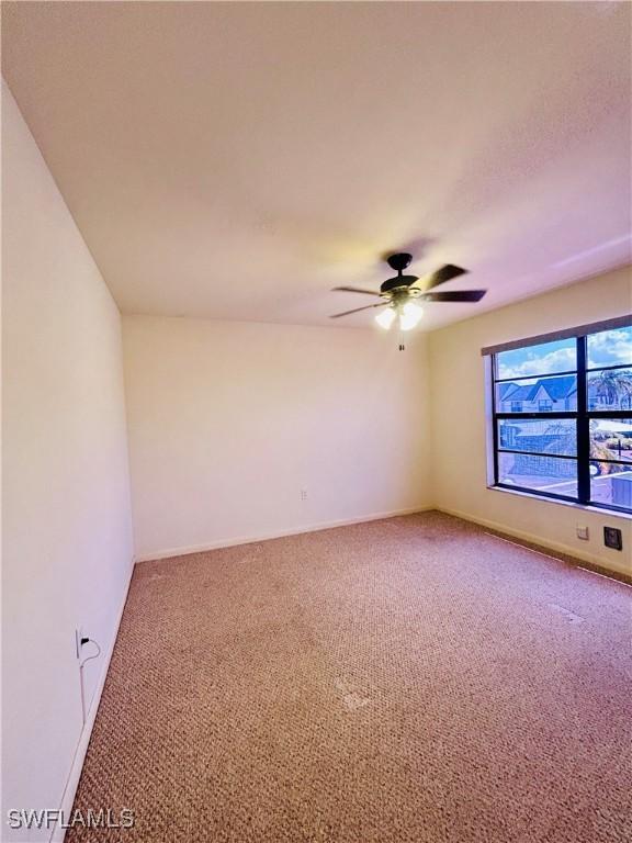 642 SE 13th Pl Unit 5, Cape Coral, FL 33990 - carpeted empty room featuring ceiling fan and baseboards