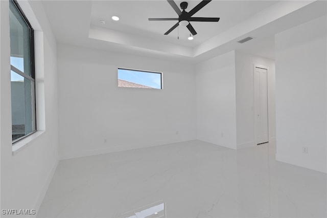 1040 NE 11th Ave, Cape Coral, FL 33909 - spare room featuring recessed lighting, marble finish flooring, a tray ceiling, and ceiling fan