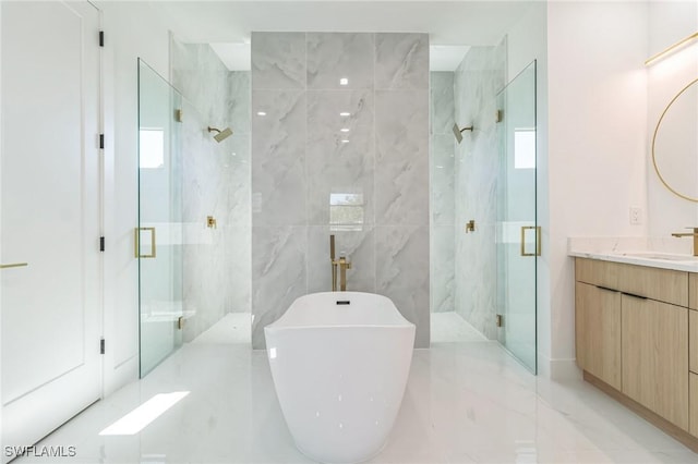 1040 NE 11th Ave, Cape Coral, FL 33909 - bathroom featuring a marble finish shower, vanity, a freestanding bath, marble finish floors, and tile walls