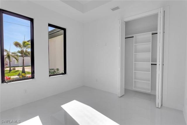 1040 NE 11th Ave, Cape Coral, FL 33909 - unfurnished bedroom featuring a closet and tile patterned flooring