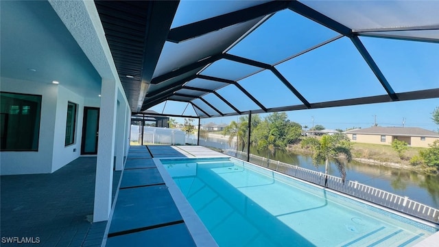 1040 NE 11th Ave, Cape Coral, FL 33909 - view of swimming pool with a patio, a water view, and a lanai