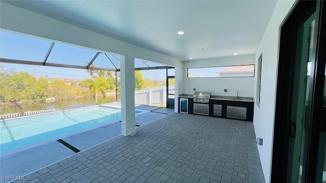 1040 NE 11th Ave, Cape Coral, FL 33909 - view of patio featuring area for grilling, a lanai, and a water view