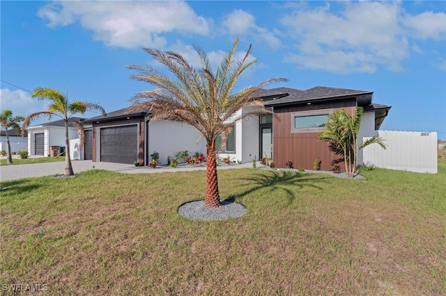 1040 NE 11th Ave, Cape Coral, FL 33909 - view of front of property featuring driveway, an attached garage, and a front lawn
