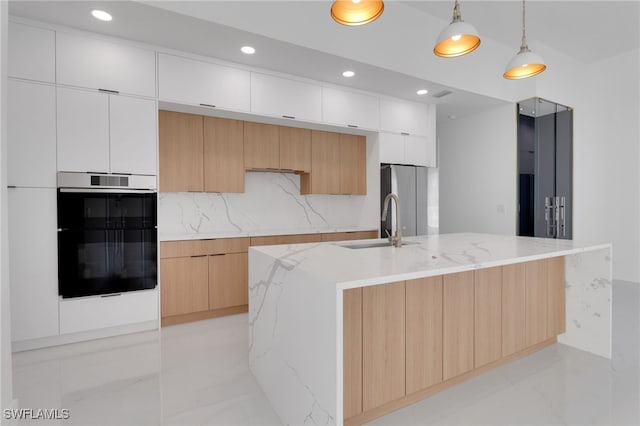 1040 NE 11th Ave, Cape Coral, FL 33909 - kitchen featuring modern cabinets, wall oven, a center island with sink, white cabinetry, and hanging light fixtures