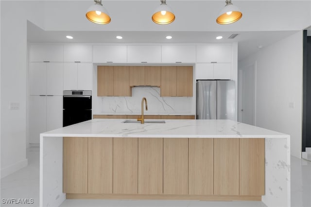 1040 NE 11th Ave, Cape Coral, FL 33909 - kitchen with stainless steel appliances, modern cabinets, white cabinetry, a large island with sink, and pendant lighting