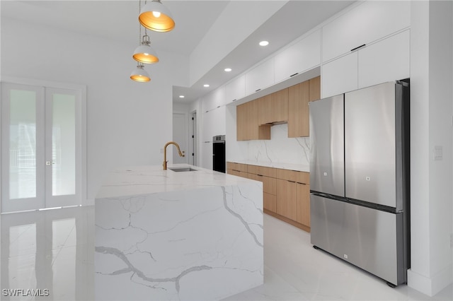 1040 NE 11th Ave, Cape Coral, FL 33909 - kitchen featuring appliances with stainless steel finishes, modern cabinets, recessed lighting, light stone countertops, and hanging light fixtures