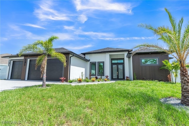 834 NW 2nd St, Cape Coral, FL 33993 - prairie-style house with french doors, a garage, concrete driveway, and a front lawn