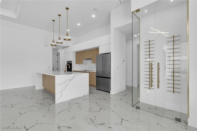 834 NW 2nd St, Cape Coral, FL 33993 - kitchen featuring modern cabinets, freestanding refrigerator, light marble finish floors, recessed lighting, and a towering ceiling