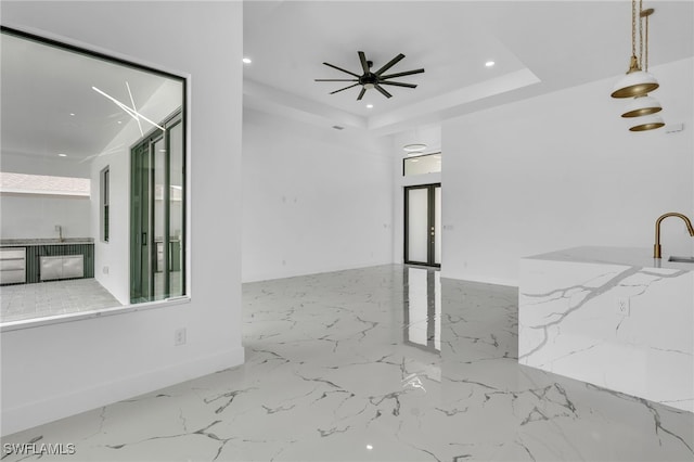 834 NW 2nd St, Cape Coral, FL 33993 - spare room with recessed lighting, marble tiled floors, a ceiling fan, and a raised ceiling