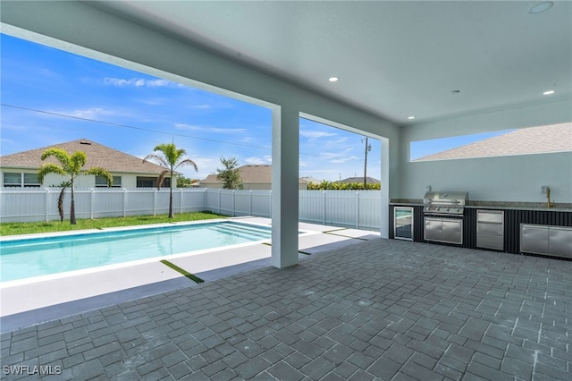 834 NW 2nd St, Cape Coral, FL 33993 - view of pool featuring exterior kitchen and a patio