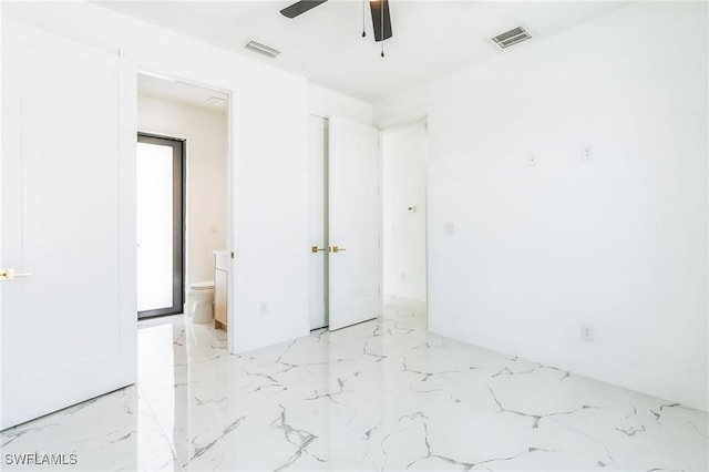 834 NW 2nd St, Cape Coral, FL 33993 - unfurnished bedroom featuring light marble finish flooring, ensuite bathroom, and a ceiling fan