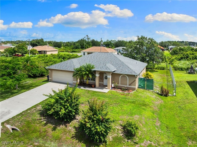 3206 8th St SW, Lehigh Acres, FL 33976 - view of front of house featuring concrete driveway, roof with shingles, stucco siding, and view of wooded area