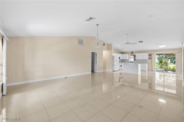 3206 8th St SW, Lehigh Acres, FL 33976 - unfurnished living room featuring light tile patterned floors, vaulted ceiling, ceiling fan, and a chandelier