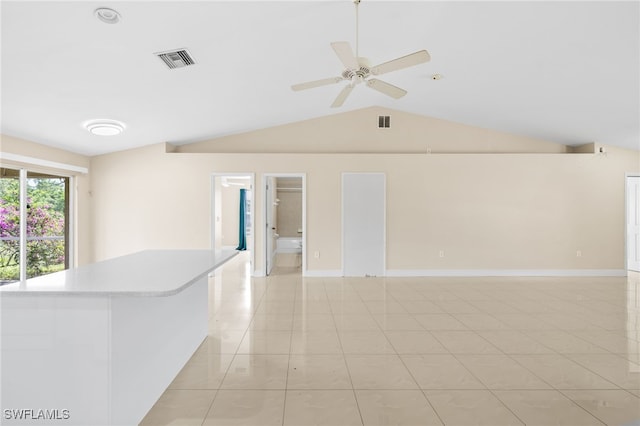 3206 8th St SW, Lehigh Acres, FL 33976 - spare room featuring vaulted ceiling, ceiling fan, and light tile patterned flooring