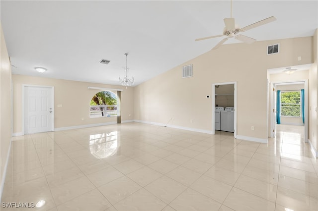 3206 8th St SW, Lehigh Acres, FL 33976 - spare room featuring washer and clothes dryer, healthy amount of natural light, light tile patterned floors, and vaulted ceiling