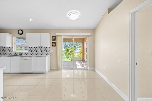 3206 8th St SW, Lehigh Acres, FL 33976 - kitchen featuring dishwasher, light countertops, backsplash, white cabinets, and light tile patterned floors
