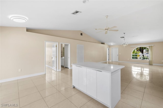 3206 8th St SW, Lehigh Acres, FL 33976 - kitchen featuring light tile patterned flooring, ceiling fan, lofted ceiling, white cabinets, and a kitchen island